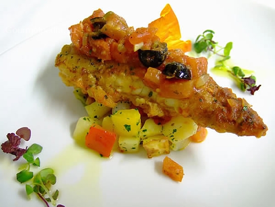 Pan-fried frogfish with tomato sauce of olive and capers